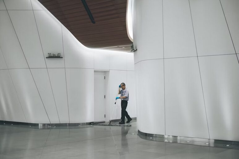 staff cleaning hallway